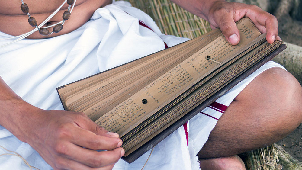 Indian man hold the Veda-s scriptures